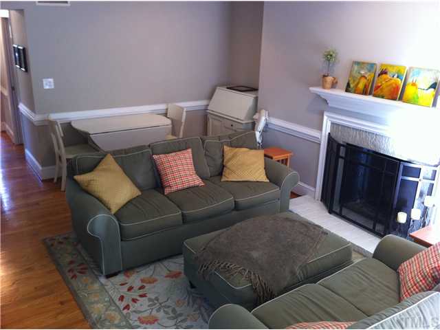 3421 Clark Avenue Raleigh, NC 27607 - Photo 4 of 19 a living room with furniture and a fireplace