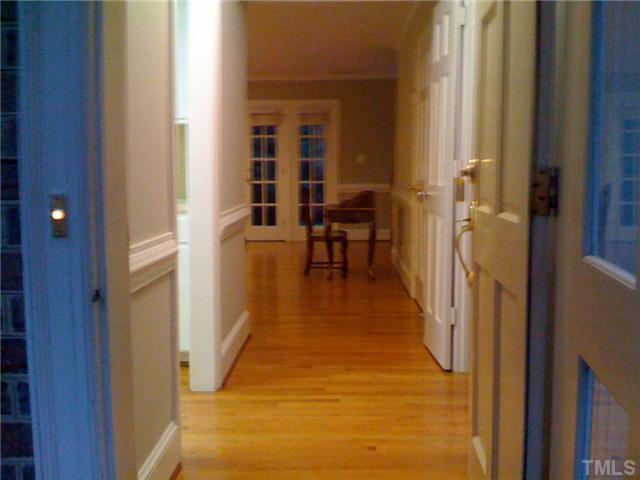 3421 Clark Avenue Raleigh, NC 27607 - Photo 5 of 19 a view of a hallway with wooden floor and furniture