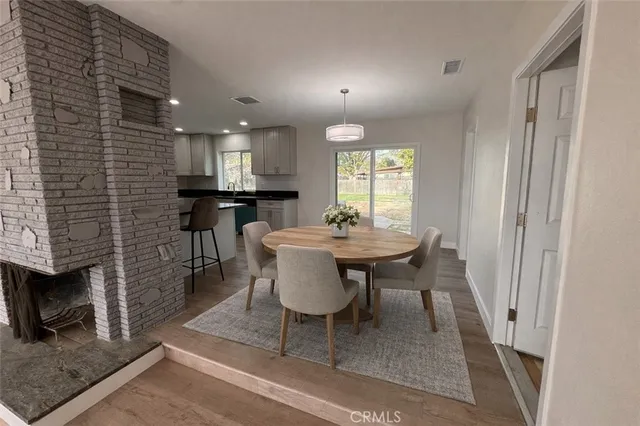 a view of a a dining room with furniture window and wooden floor