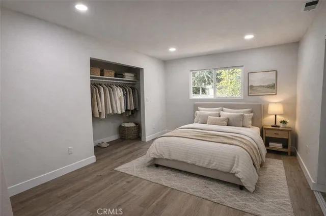 a bedroom with a bed and a painting on the wall