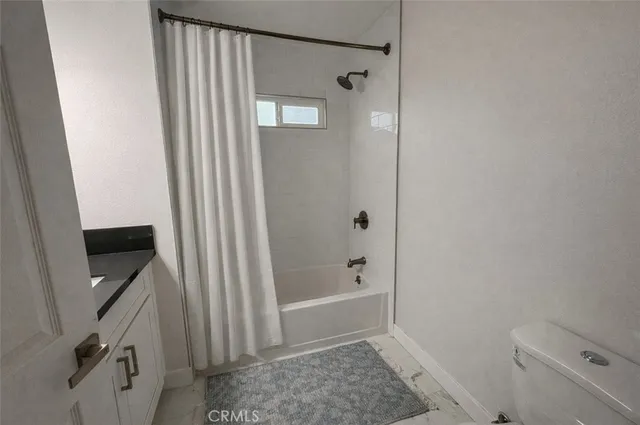 a bathroom with a shower and toilet