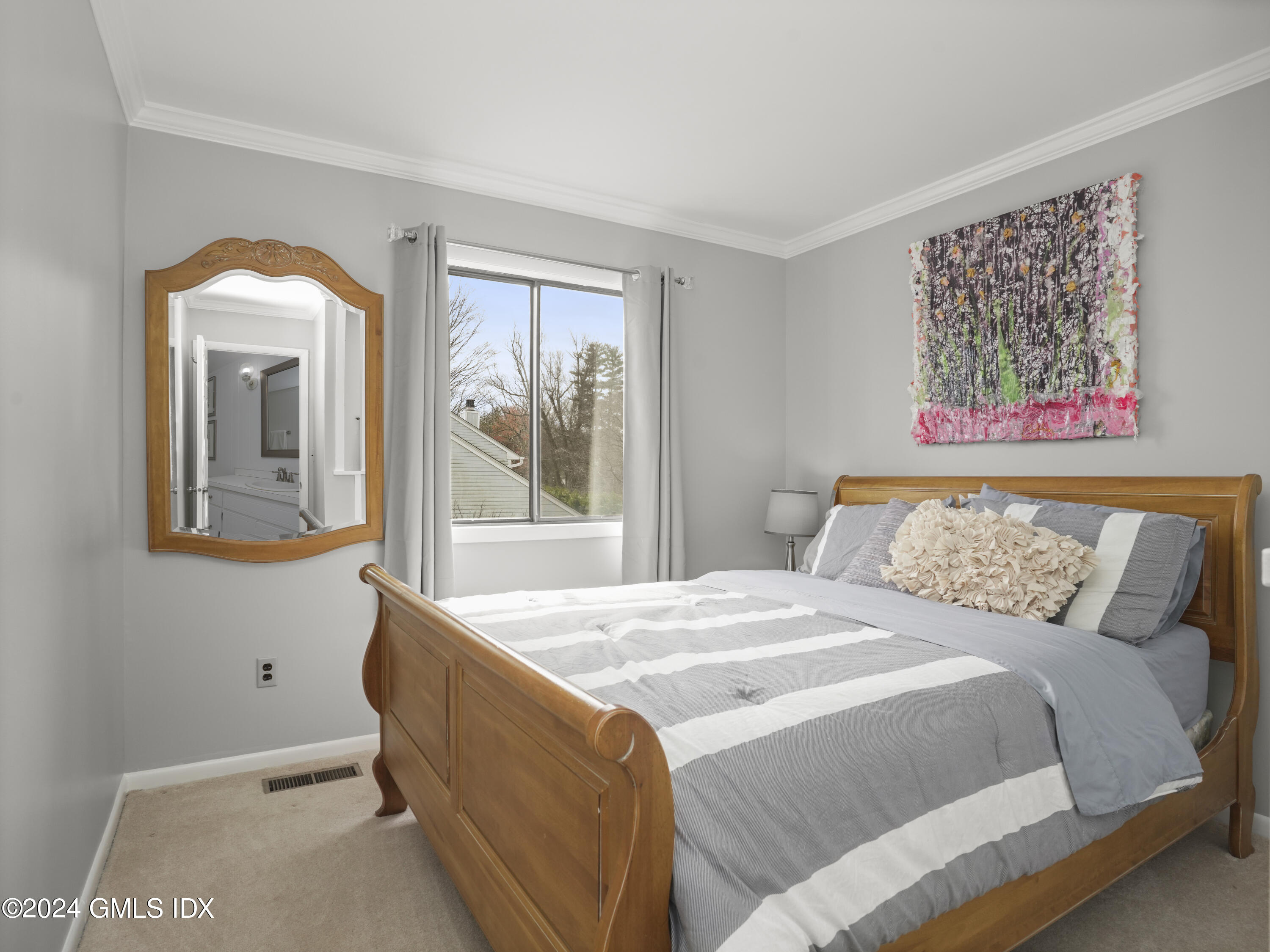 102 Silo Circle, Unit 102 Riverside, CT 06878 - Photo 14 of 22 a bedroom with a bed and a painting on the wall