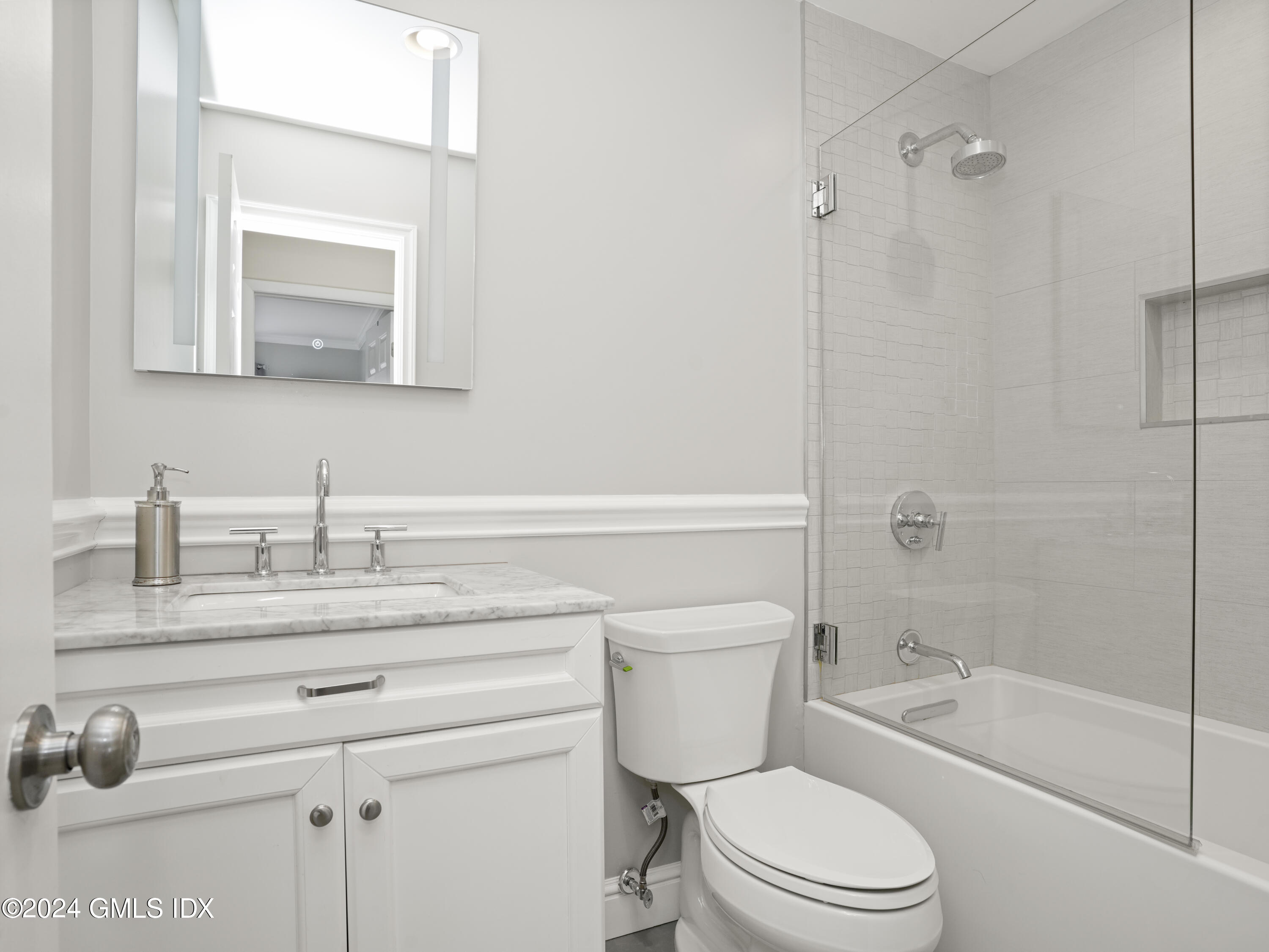 102 Silo Circle, Unit 102 Riverside, CT 06878 - Photo 15 of 22 a bathroom with a granite countertop toilet sink a mirror and shower