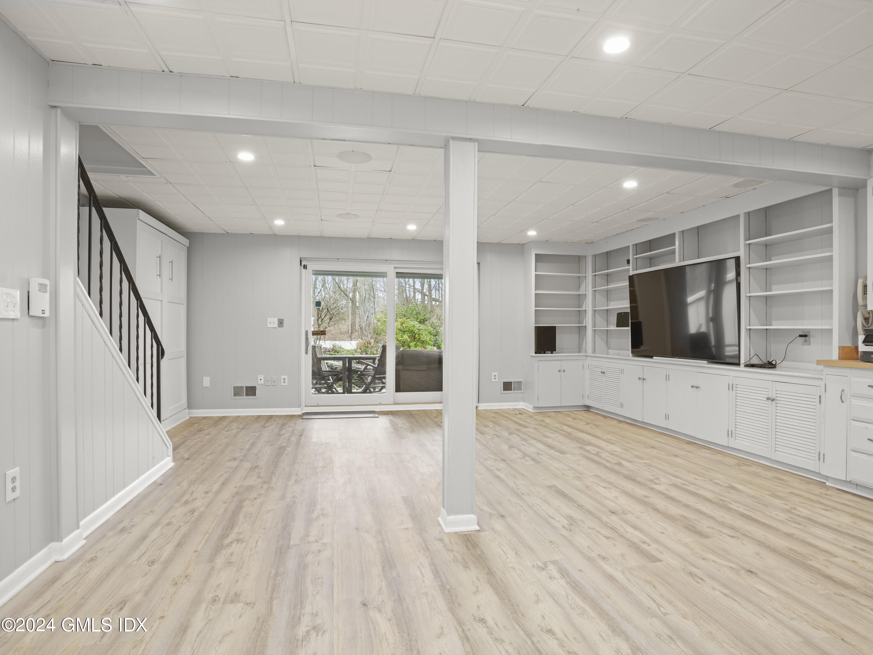 102 Silo Circle, Unit 102 Riverside, CT 06878 - Photo 18 of 22 a view of an empty room with wooden floor and a window