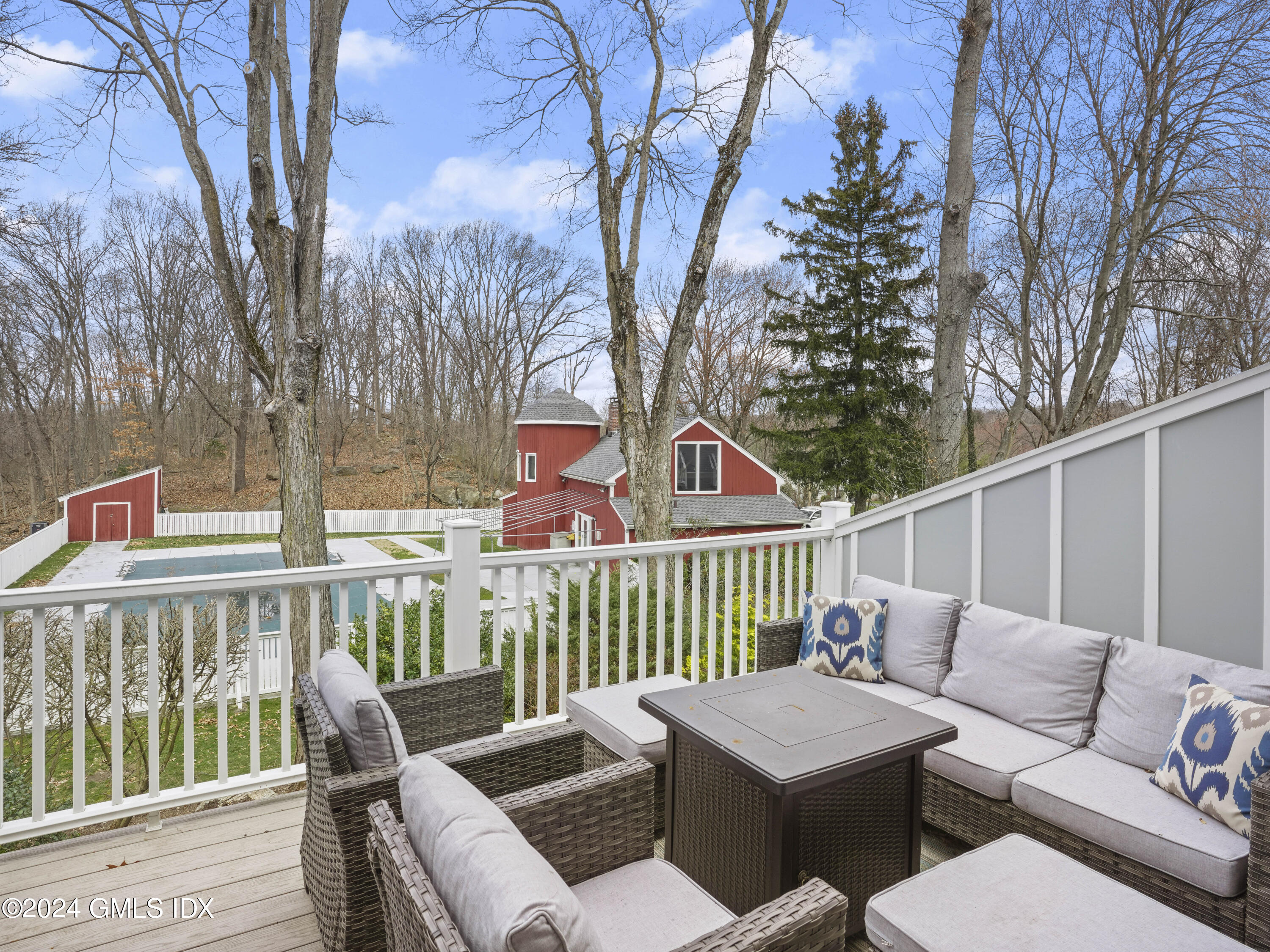 102 Silo Circle, Unit 102 Riverside, CT 06878 - Photo 8 of 22 a roof deck with couches and wooden fence