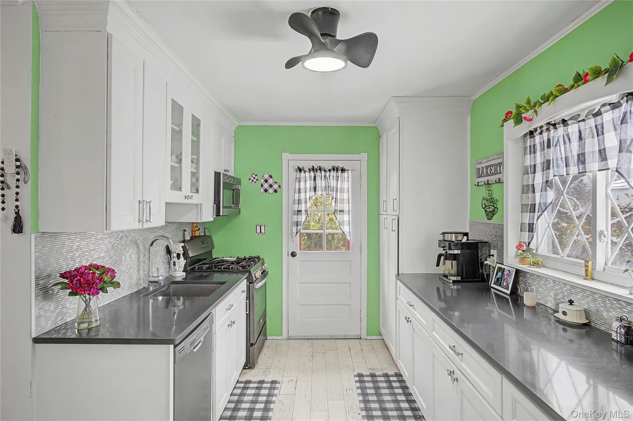 9 Amherst Road West Sayville, NY 11796 - Photo 4 of 22 a kitchen with a sink cabinets and window