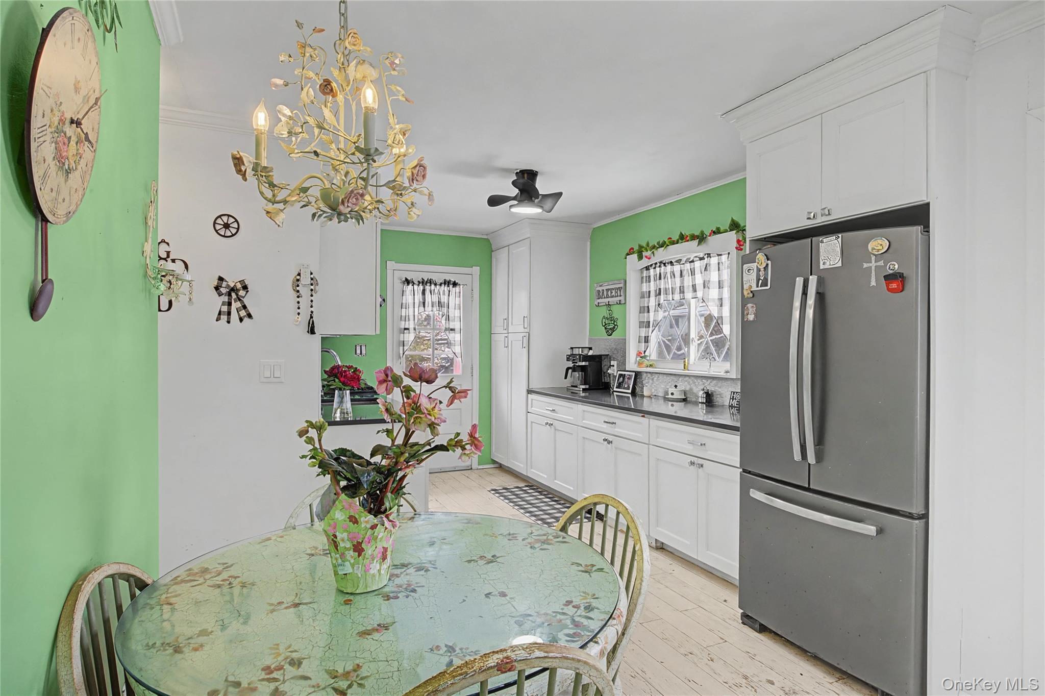 9 Amherst Road West Sayville, NY 11796 - Photo 5 of 22 a kitchen with stainless steel appliances granite countertop a refrigerator a sink and a dining table