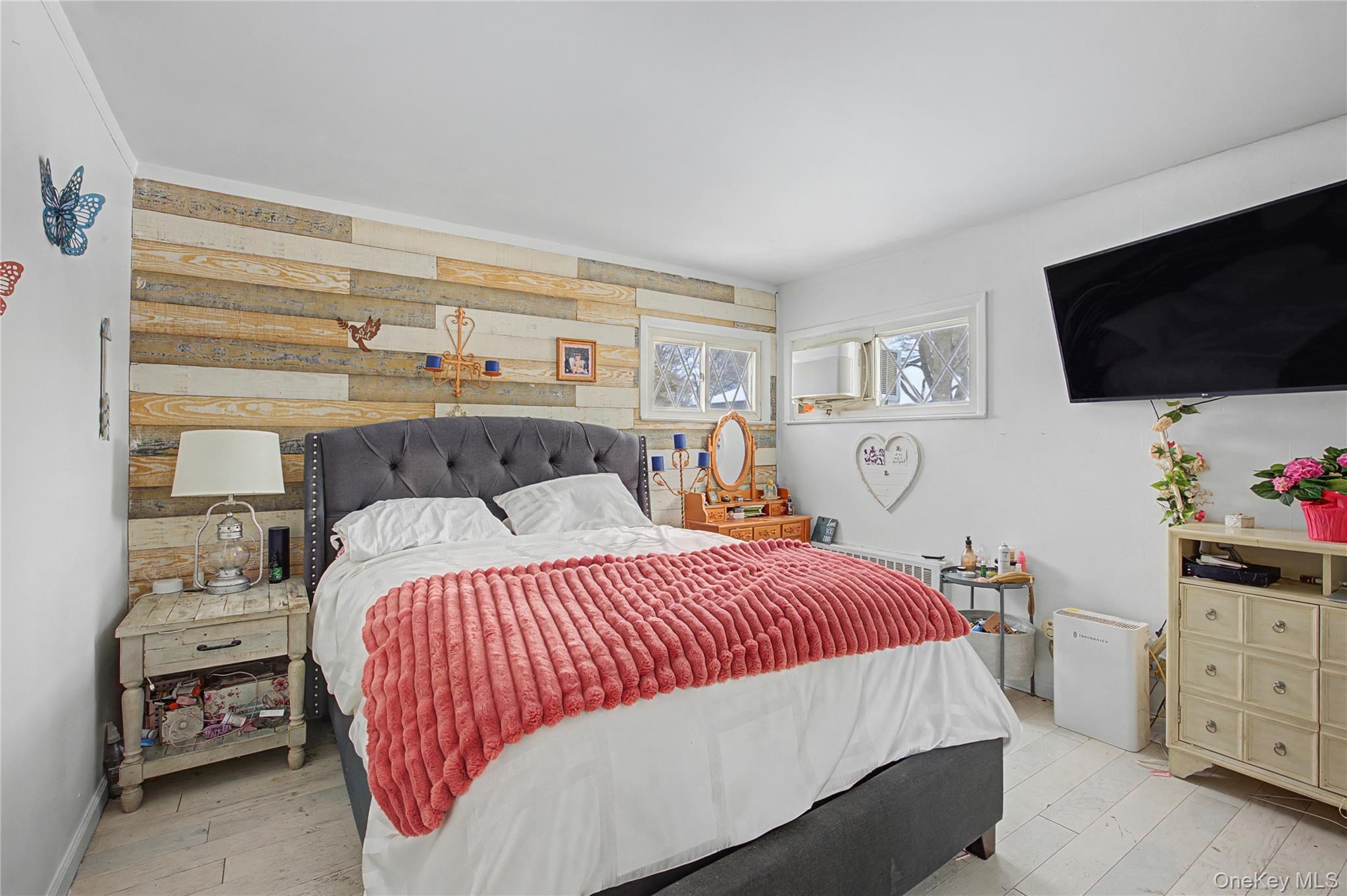 9 Amherst Road West Sayville, NY 11796 - Photo 7 of 22 a bedroom with a bed and a flat screen tv
