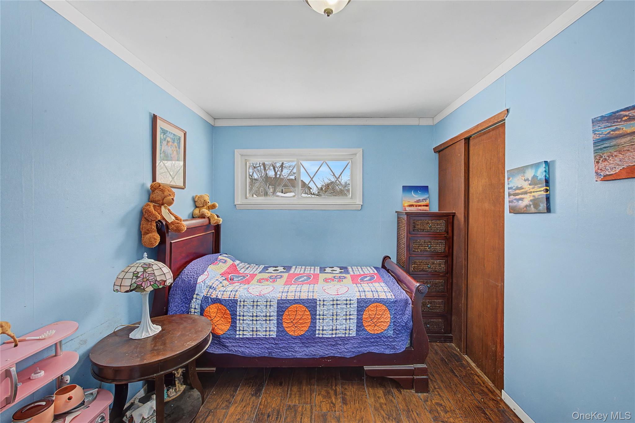 9 Amherst Road West Sayville, NY 11796 - Photo 9 of 22 a bedroom with furniture and a small wooden floor