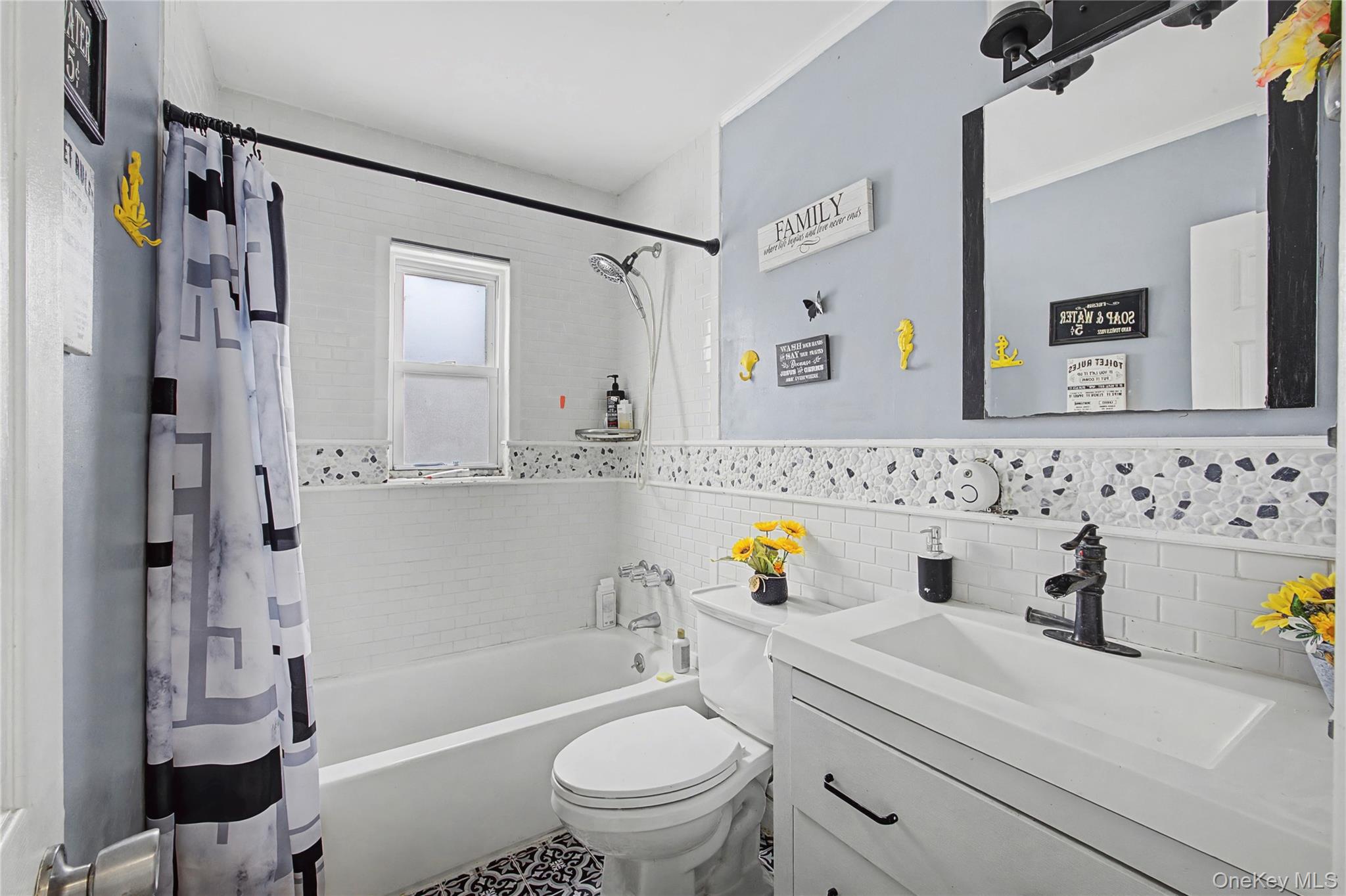 9 Amherst Road West Sayville, NY 11796 - Photo 10 of 22 a bathroom with a sink a toilet and a bathtub