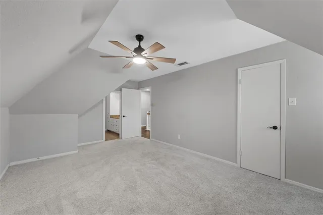 a view of an empty room with a fan