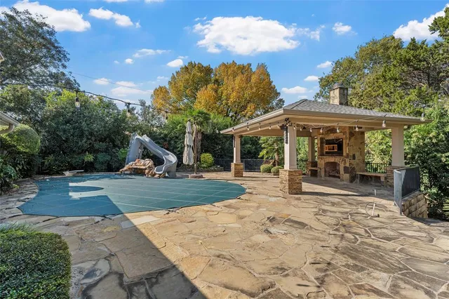 a view of a house with backyard porch and sitting area