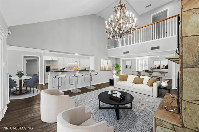 a living room with furniture and a chandelier