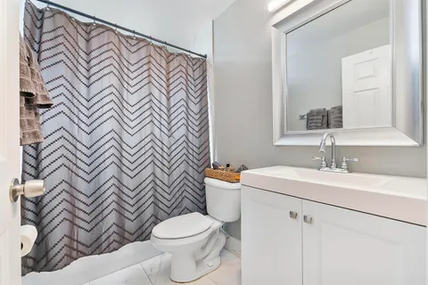 a bathroom with a sink a toilet and a mirror
