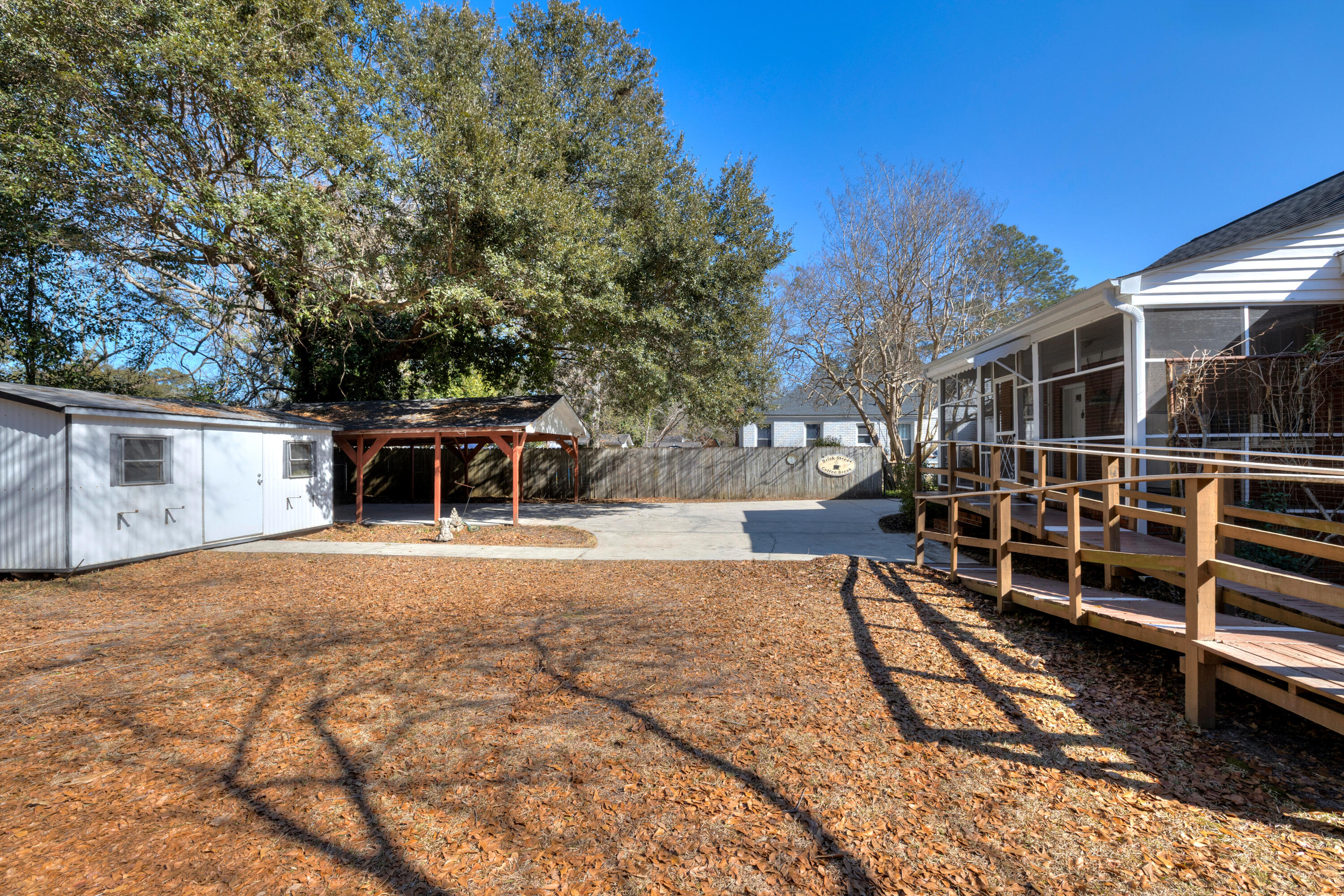 537 West Calhoun Street Sumter, SC 29150 - Photo 13 of 40 back yard, storage shed, carport and ramp to screened porch