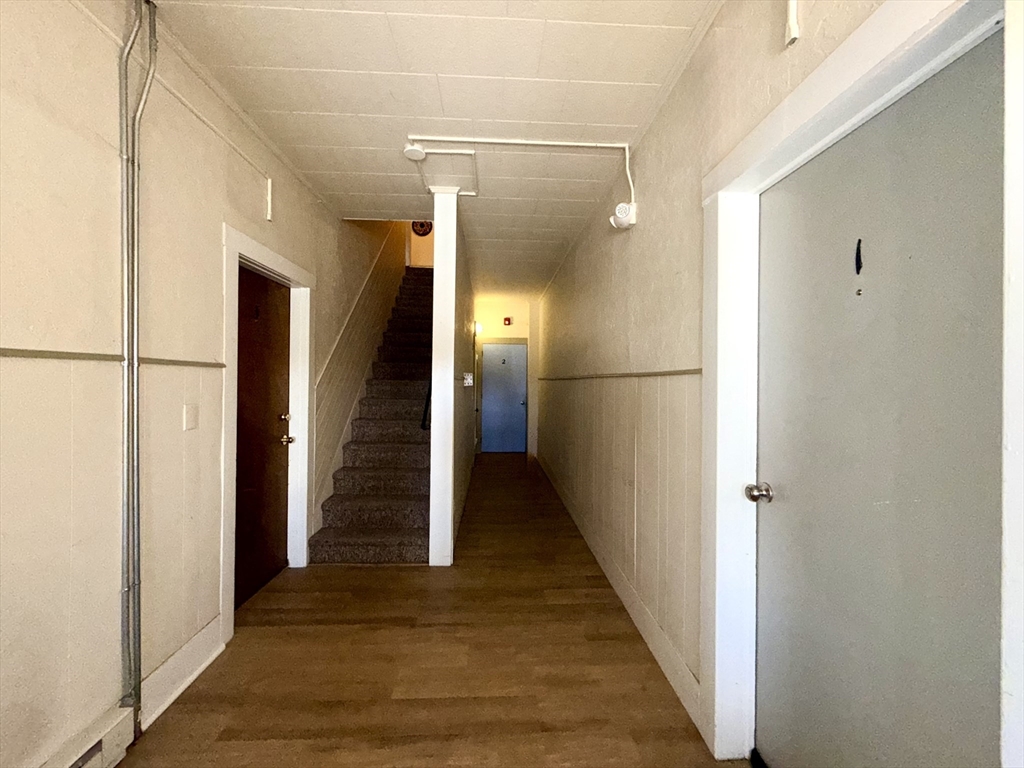 17 Adams Street Easthampton, MA 01027 - Photo 14 of 24 a view of a hallway with wooden floor and staircase