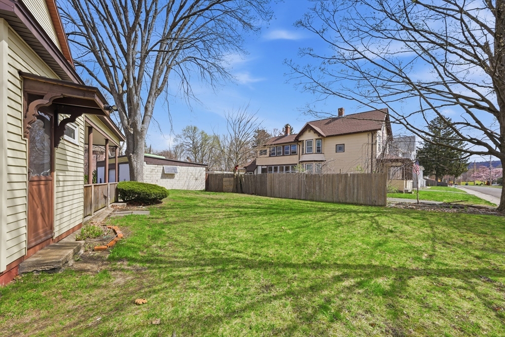 17 Adams Street Easthampton, MA 01027 - Photo 3 of 24 a view of a backyard with a large tree