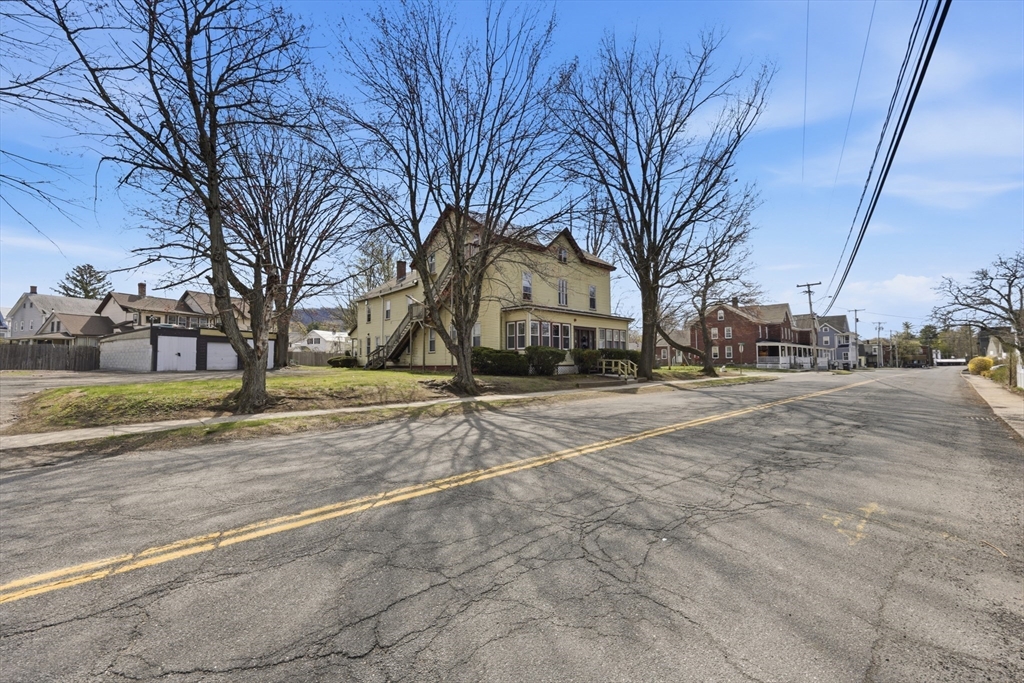 17 Adams Street Easthampton, MA 01027 - Photo 5 of 24 a street view with large trees