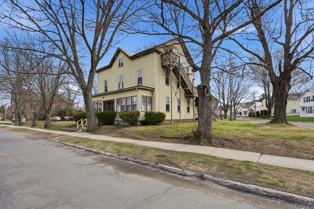 17 Adams Street Easthampton, MA 01027 - Photo 7 of 24 a view of a house with a yard and large trees