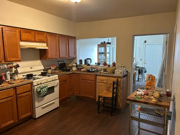 a kitchen with a sink cabinets and wooden floor