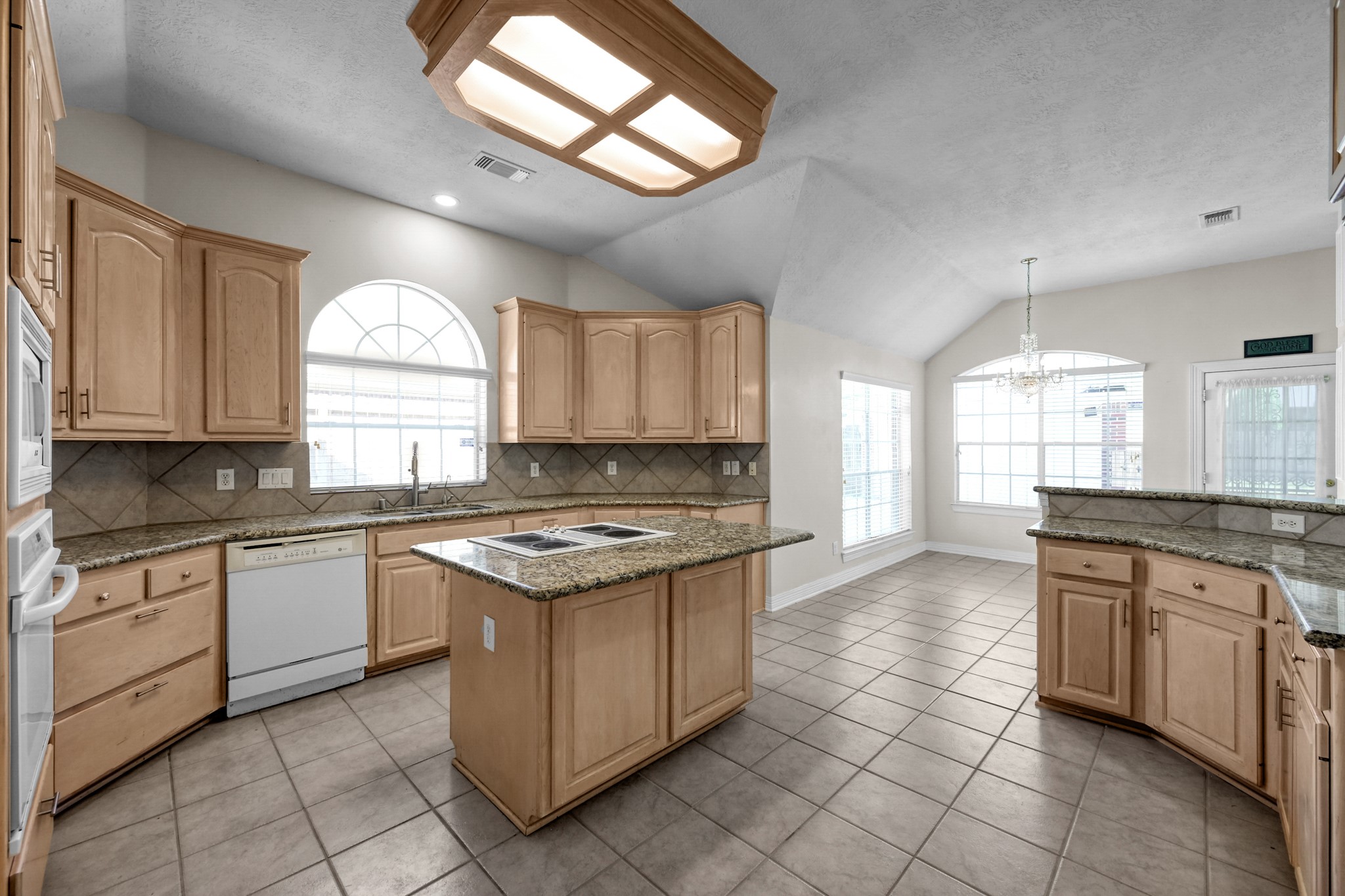 16214 Lobo Lane Spring, TX 77379 - Photo 7 of 25 Spacious Kitchen with granite countertops, plenty of storage space, and island cooktop.