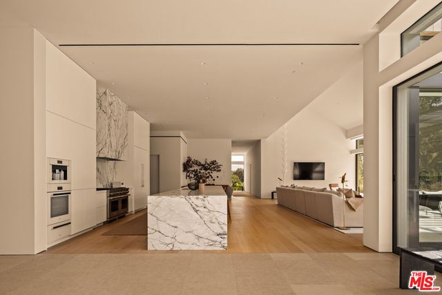a view of a kitchen with a sink and cabinets