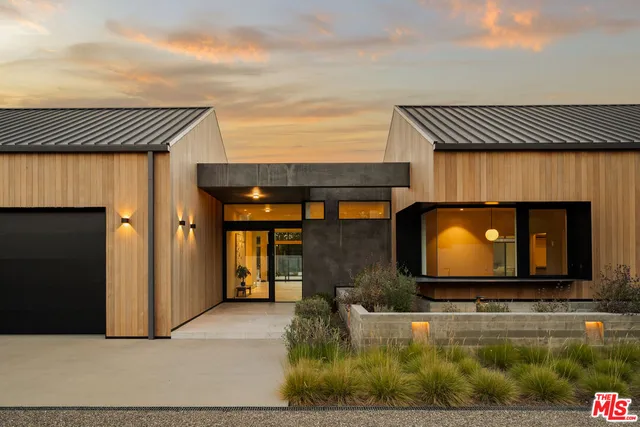 a view of backyard with large trees and wooden fence