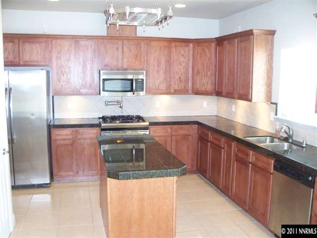 4891 Rancheria Road Fallon, NV 89406 - Photo 4 of 13 a kitchen with a sink and a refrigerator