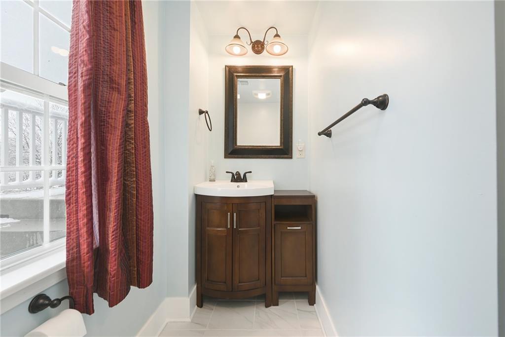 1608 Seegar Road Pittsburgh, PA 15241 - Photo 20 of 23 a bathroom with a sink a mirror and a window