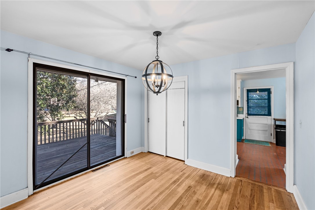 420 Brock Street Central, SC 29630 - Photo 20 of 45 This bright space features a glass sliding door, hardwood floors, and an elegant hanging light fixture.