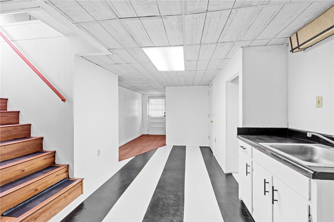 420 Brock Street Central, SC 29630 - Photo 26 of 45 This versatile basement space features a convenient kitchenette and stylish striped flooring.