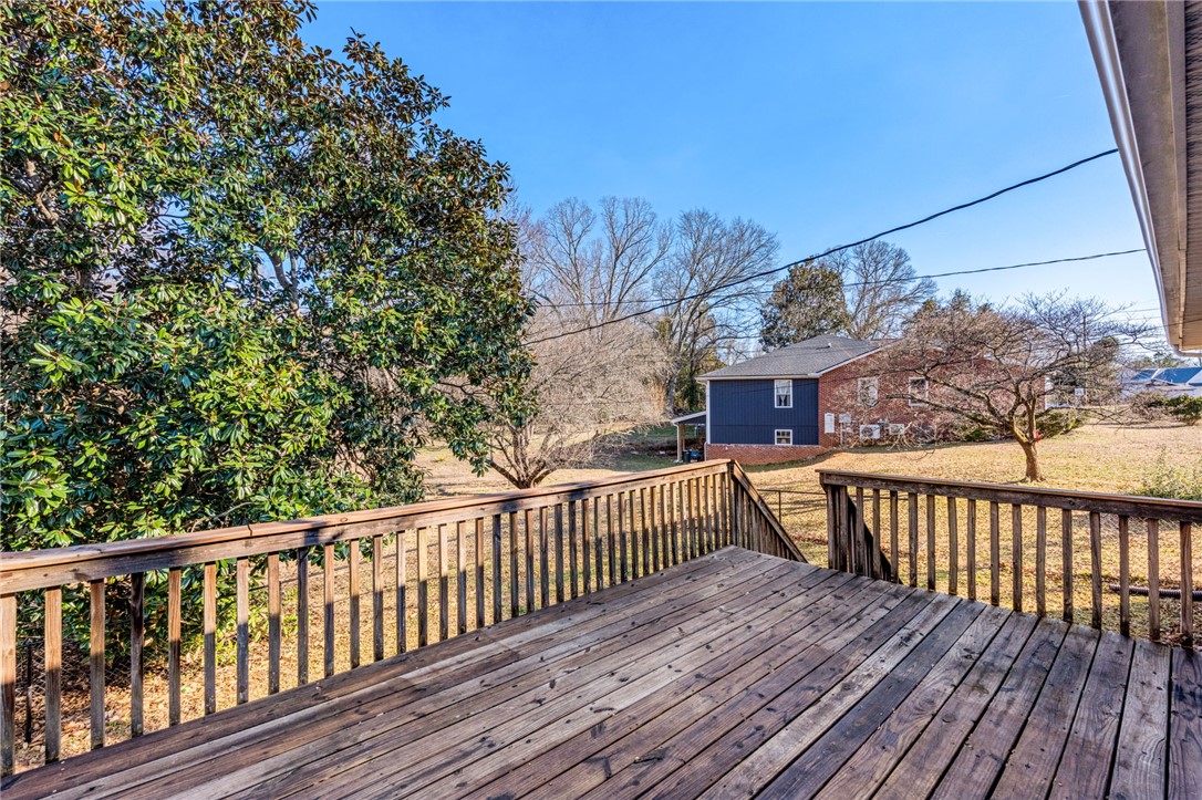 420 Brock Street Central, SC 29630 - Photo 37 of 45 This spacious wooden deck overlooks a tranquil yard and offers ample space for outdoor relaxation.