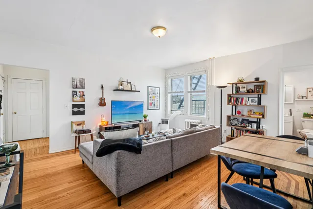 a living room with furniture a rug and a bookshelf