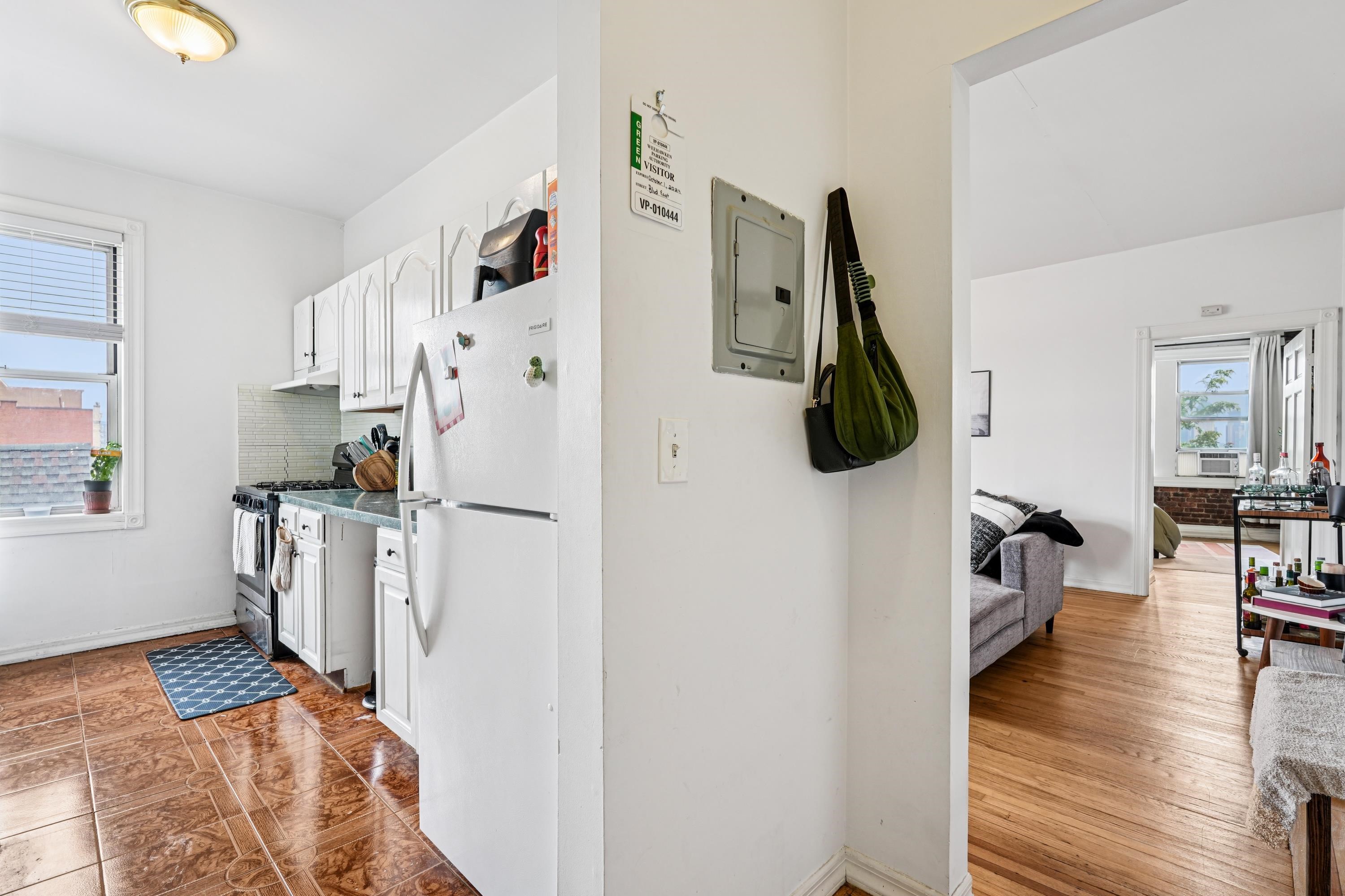 851 Boulevard East, Unit D2 Weehawken, NJ 07086 - Photo 13 of 42 a kitchen with stainless steel appliances a refrigerator and a wooden floor