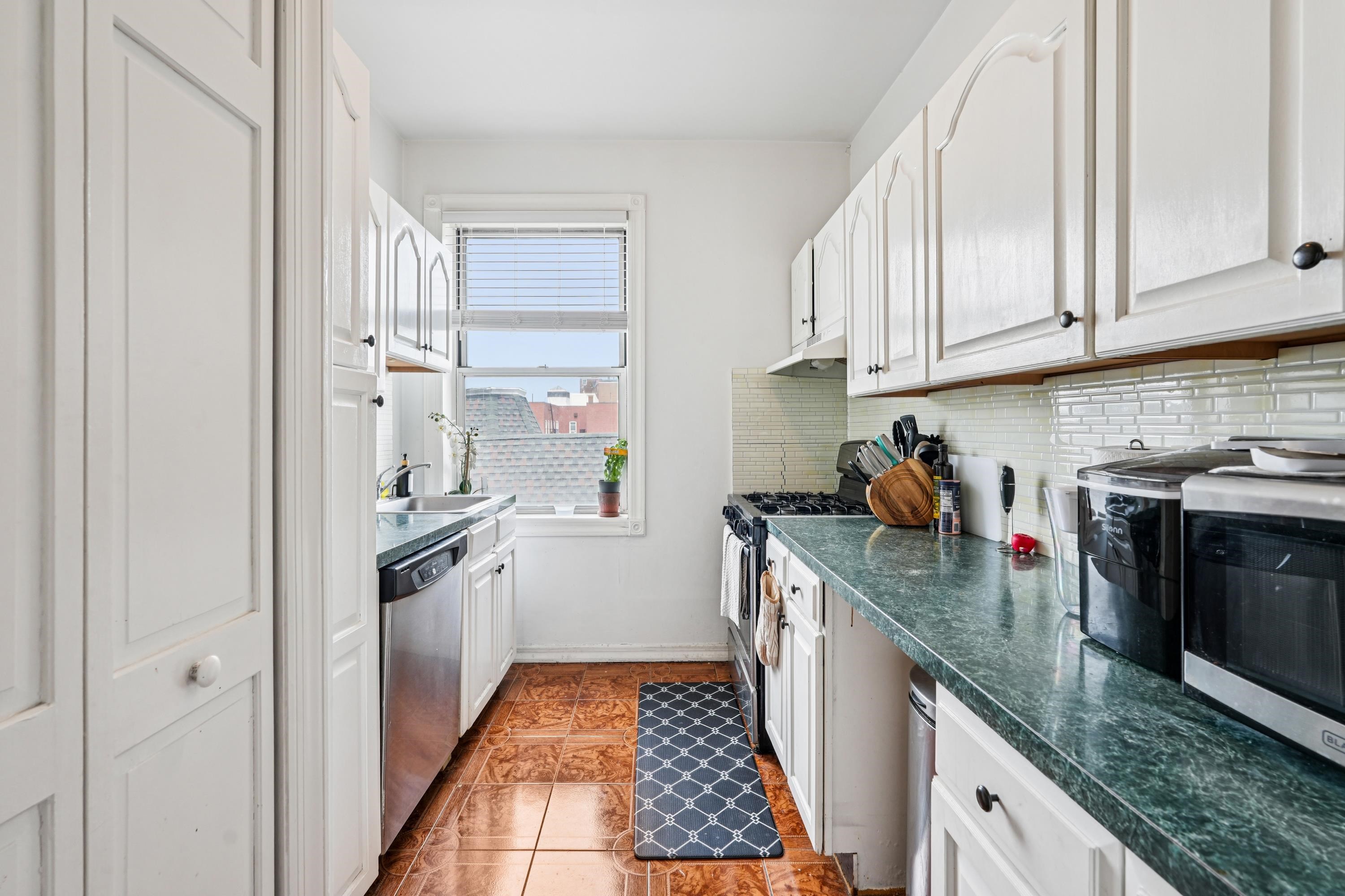 851 Boulevard East, Unit D2 Weehawken, NJ 07086 - Photo 15 of 42 a kitchen with stainless steel appliances granite countertop a sink stove and refrigerator