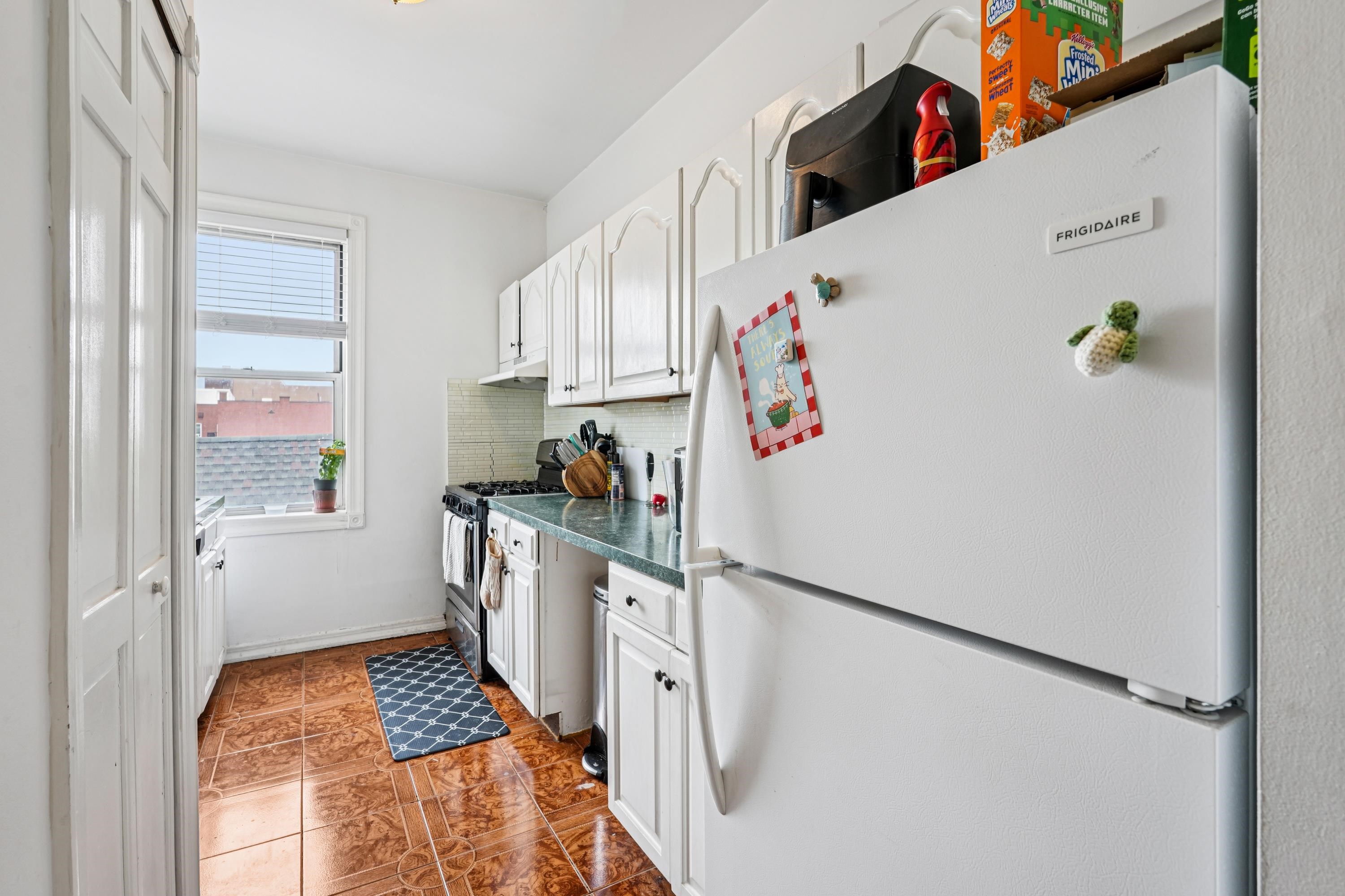 851 Boulevard East, Unit D2 Weehawken, NJ 07086 - Photo 16 of 42 a kitchen with a refrigerator a stove a sink and a window