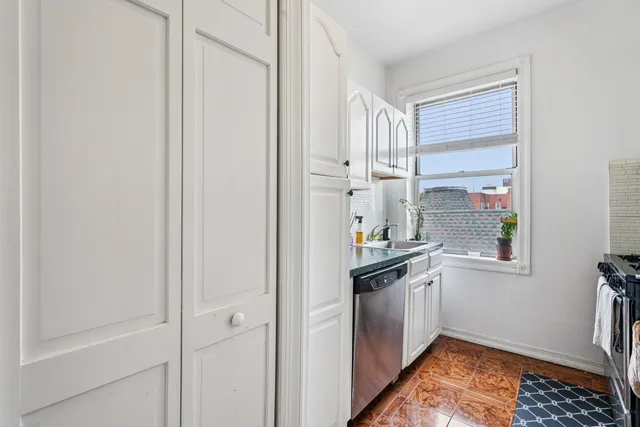 a kitchen with stainless steel appliances granite countertop a sink and a refrigerator
