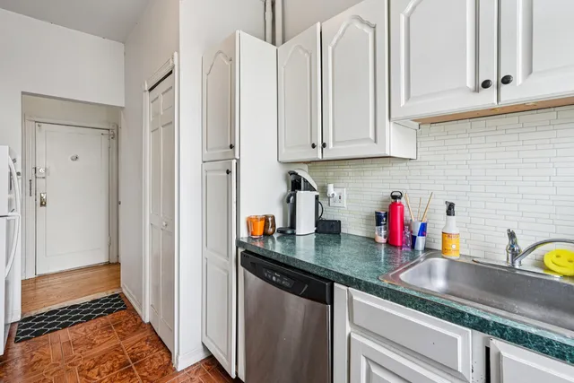a kitchen with stainless steel appliances granite countertop a sink dishwasher stove and cabinets