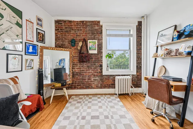 a living room with furniture a rug and a window