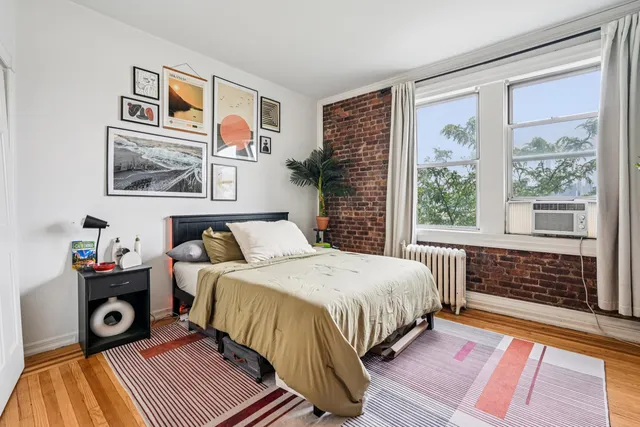 a bedroom with a bed and a window