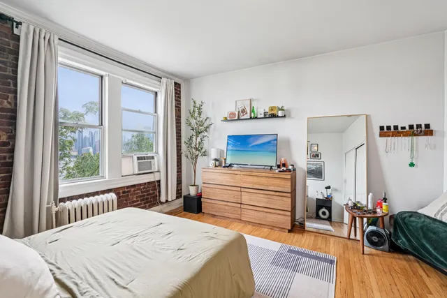 a bedroom with a bed and a dresser