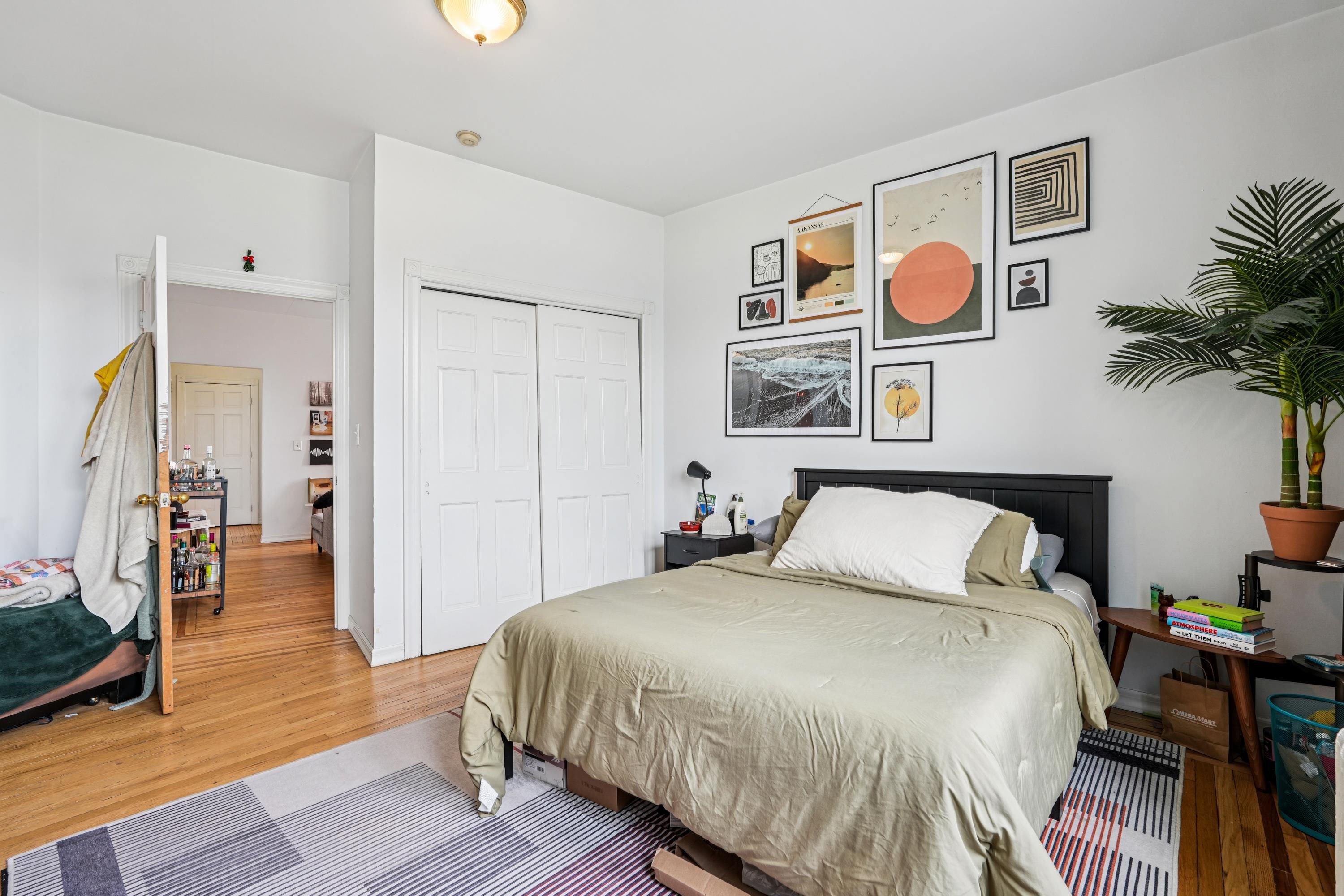 851 Boulevard East, Unit D2 Weehawken, NJ 07086 - Photo 31 of 42 a bedroom with a bed and painting on the wall