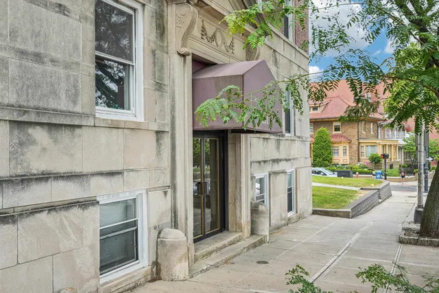 a view of a brick house with a large windows