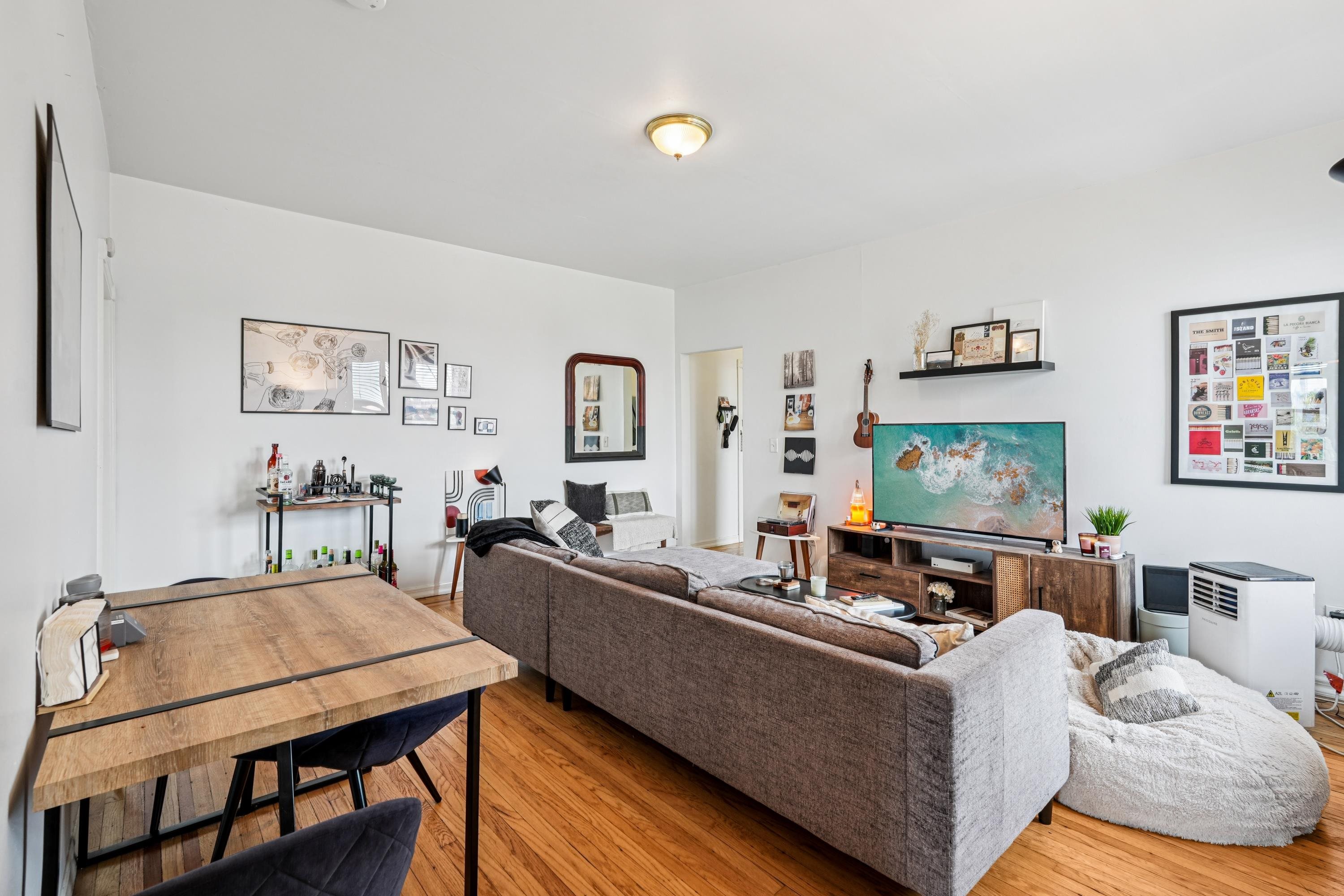 851 Boulevard East, Unit D2 Weehawken, NJ 07086 - Photo 7 of 42 a living room with furniture and a flat screen tv