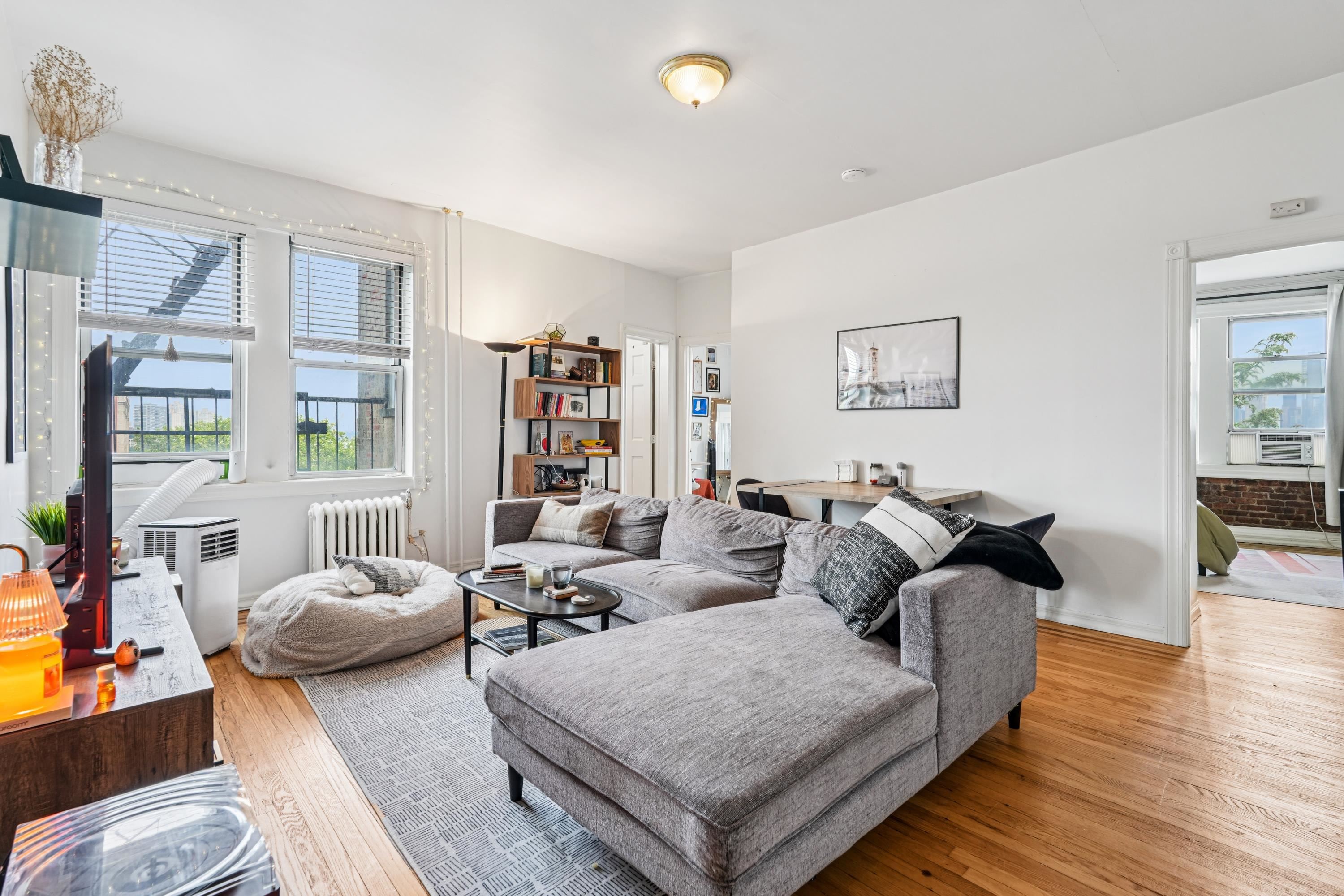 851 Boulevard East, Unit D2 Weehawken, NJ 07086 - Photo 10 of 42 a living room with furniture and a wooden floor
