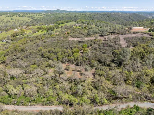 a view of a field with an ocean view
