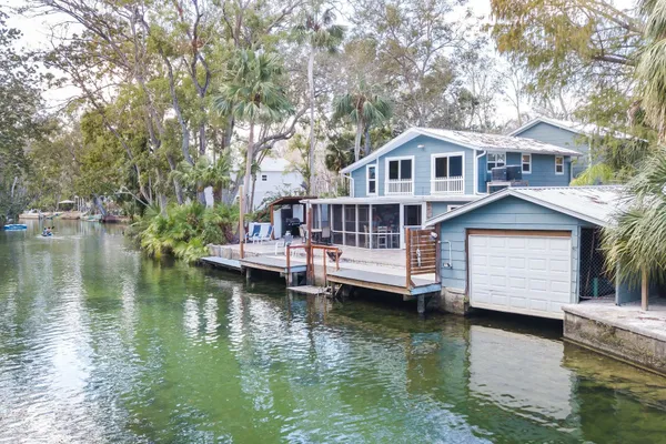 a view of house with yard outdoor seating and lake view