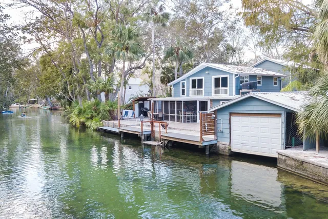 a view of house with yard outdoor seating and lake view