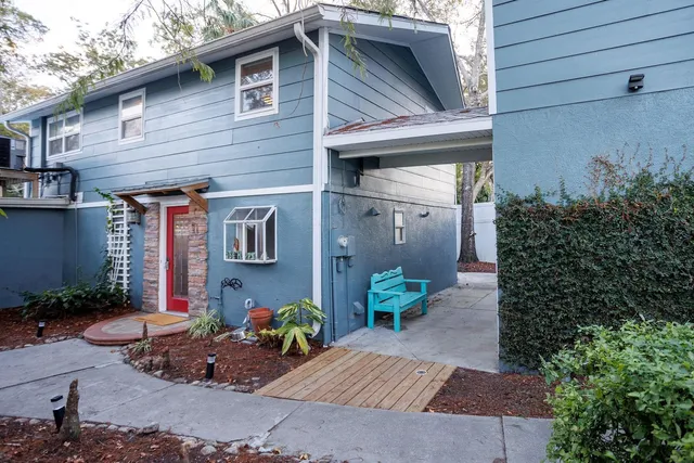 a open kitchen with stainless steel appliances kitchen island granite countertop a table and chairs in it