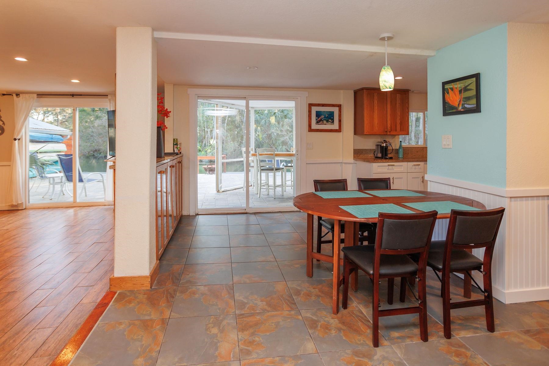 6194 Bear Trail Weeki Wachee, FL 34607 - Photo 14 of 68 a view of a dining room with furniture window and wooden floor